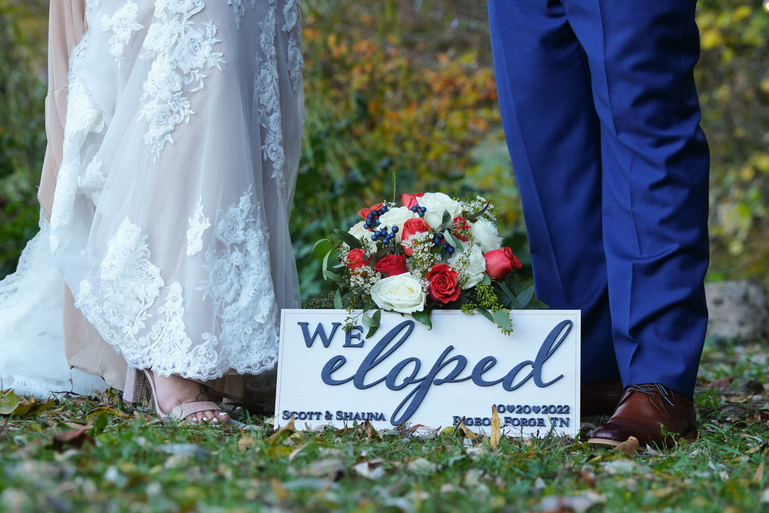 We Eloped sign with bouquet at a bride and groom's feet