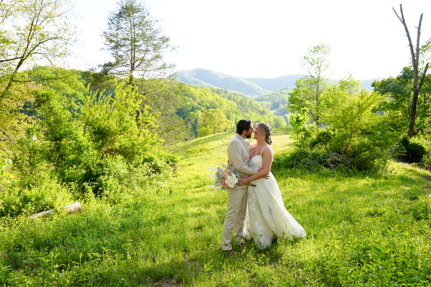 Mountain view wedding couple at Honeysuckle Hills in Pigeon Forge in early spring in a field