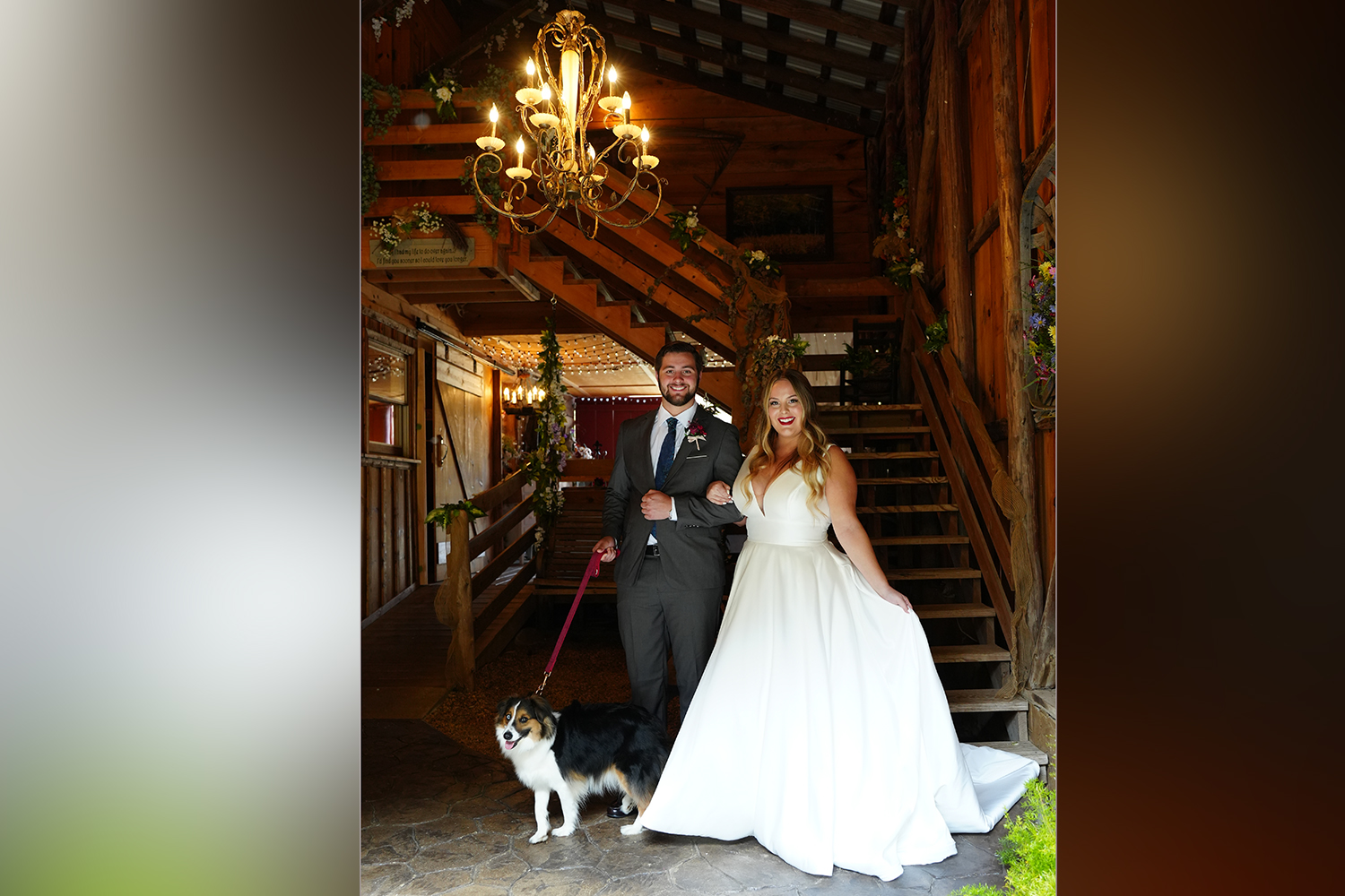 Rustic wedding chandelier with a couple arm in arm with their dog