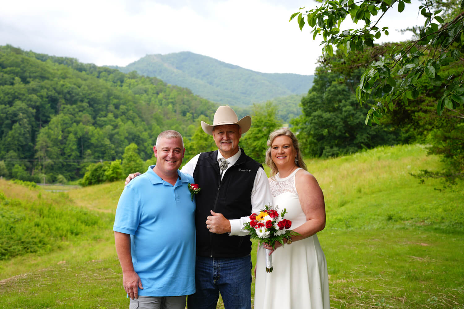 Pastor Lloyd with a couple he just married at the mountain view site at Honeysuckle Hills in Pigeon Forge