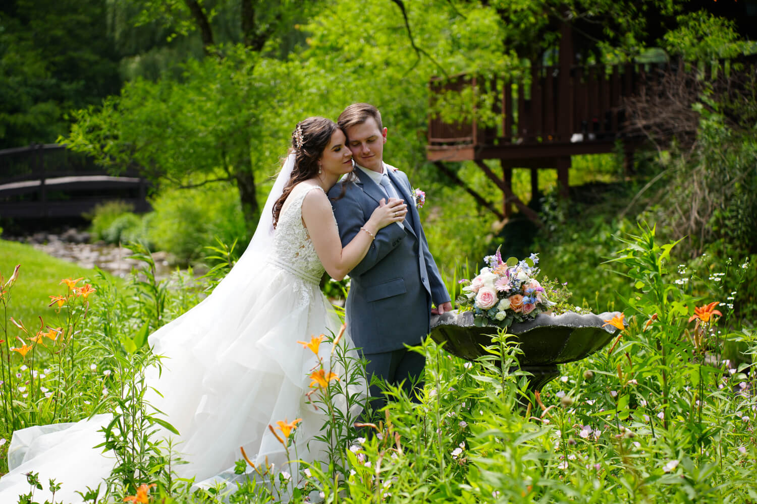 Wedding portrait in the summer gardens by the creek at Honeysuckle Hills in Pigeon Forge
