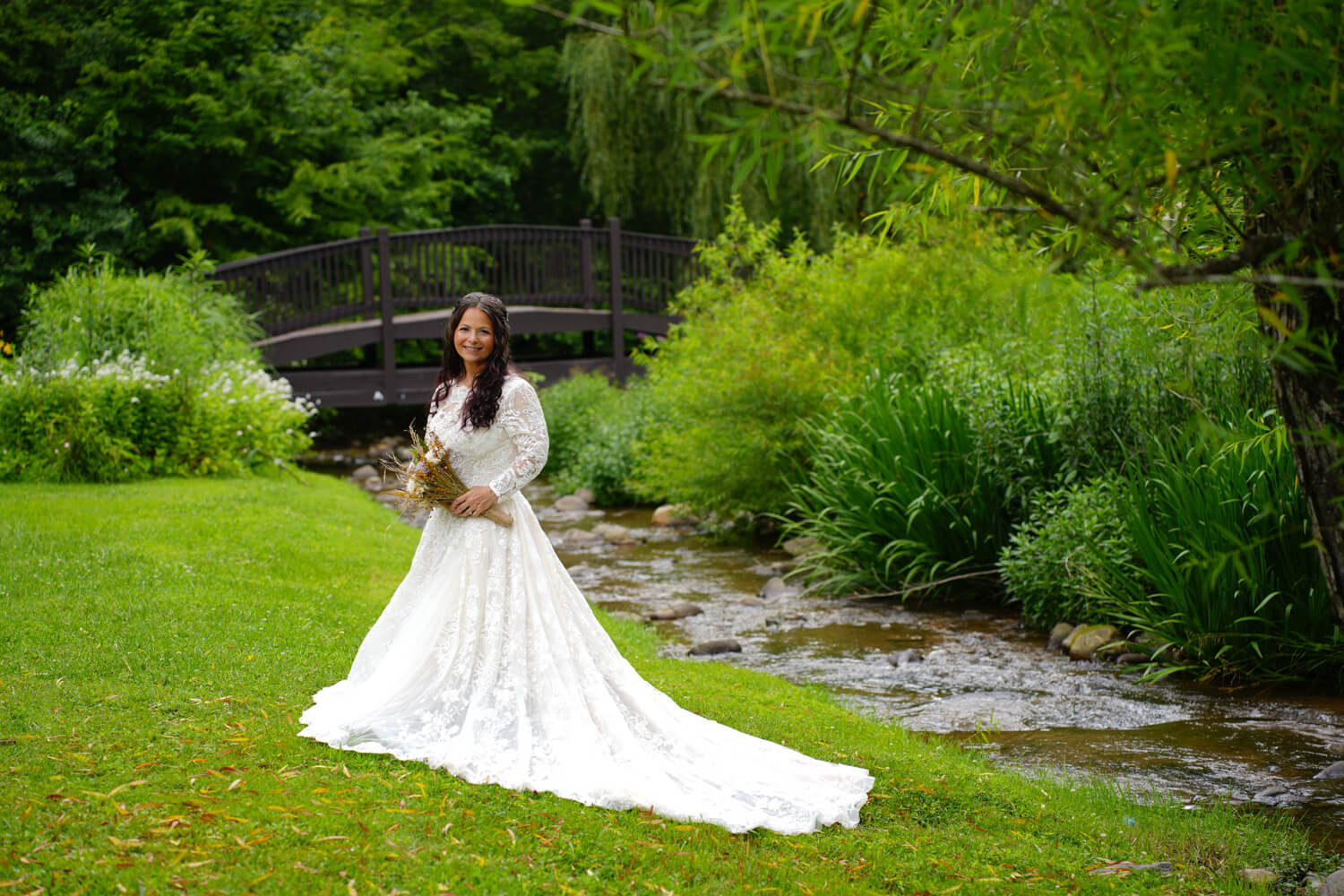 Bridal portrait by a creek and arched bridge at Honeysuckle hills in Pigeon Forge