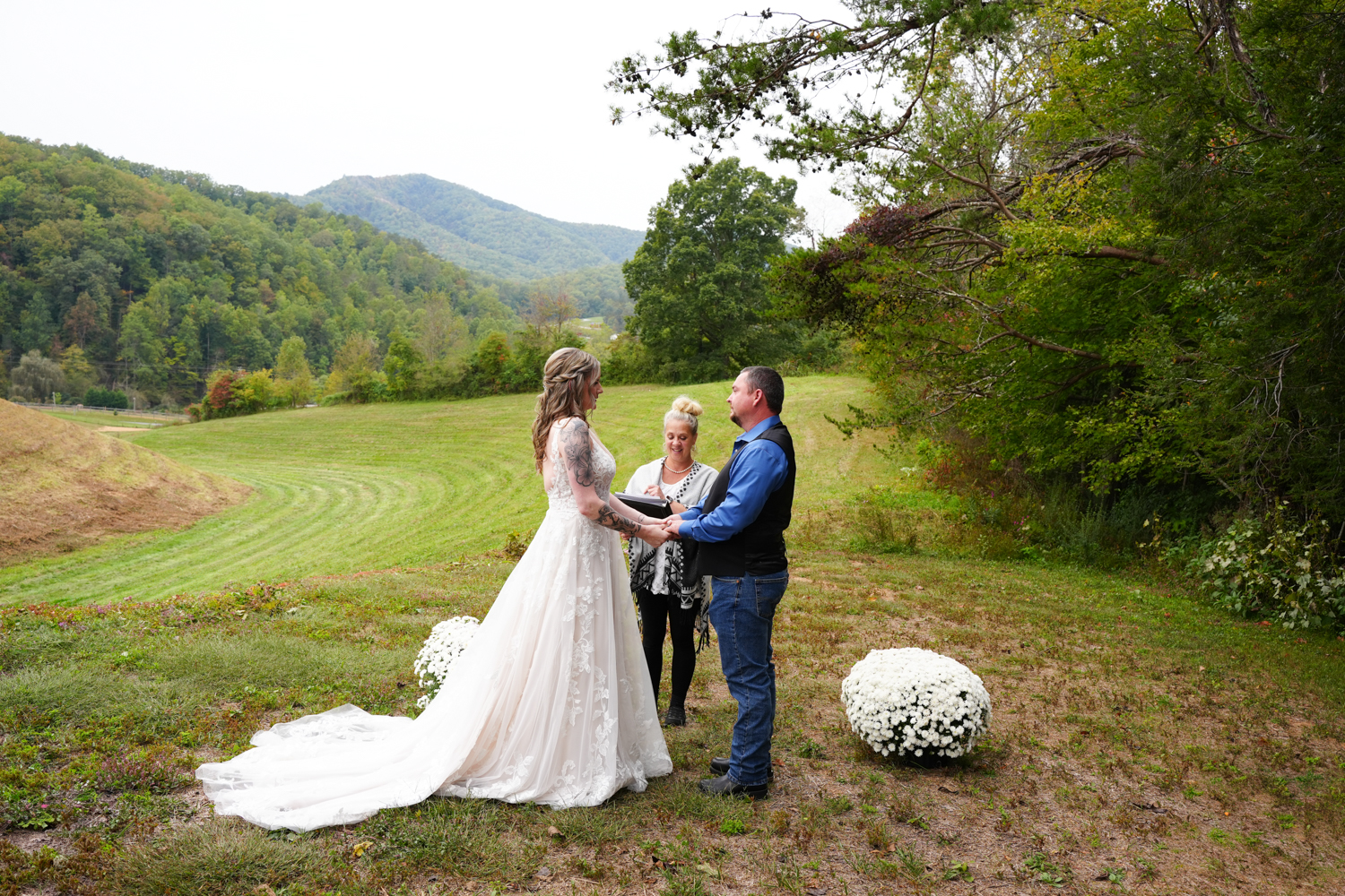 Regina Starkey officiating a wedding at the mountain view site of her family farm wedding venue called Honeysuckle Hills