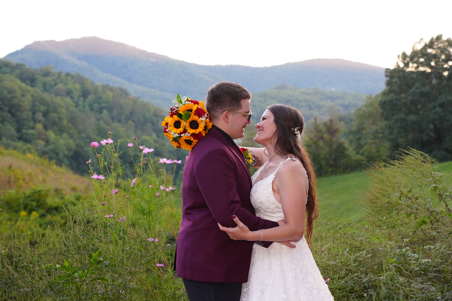Wedding couple gazing into each others eyes at a mountain view with a meadow behind them in East Tennessee