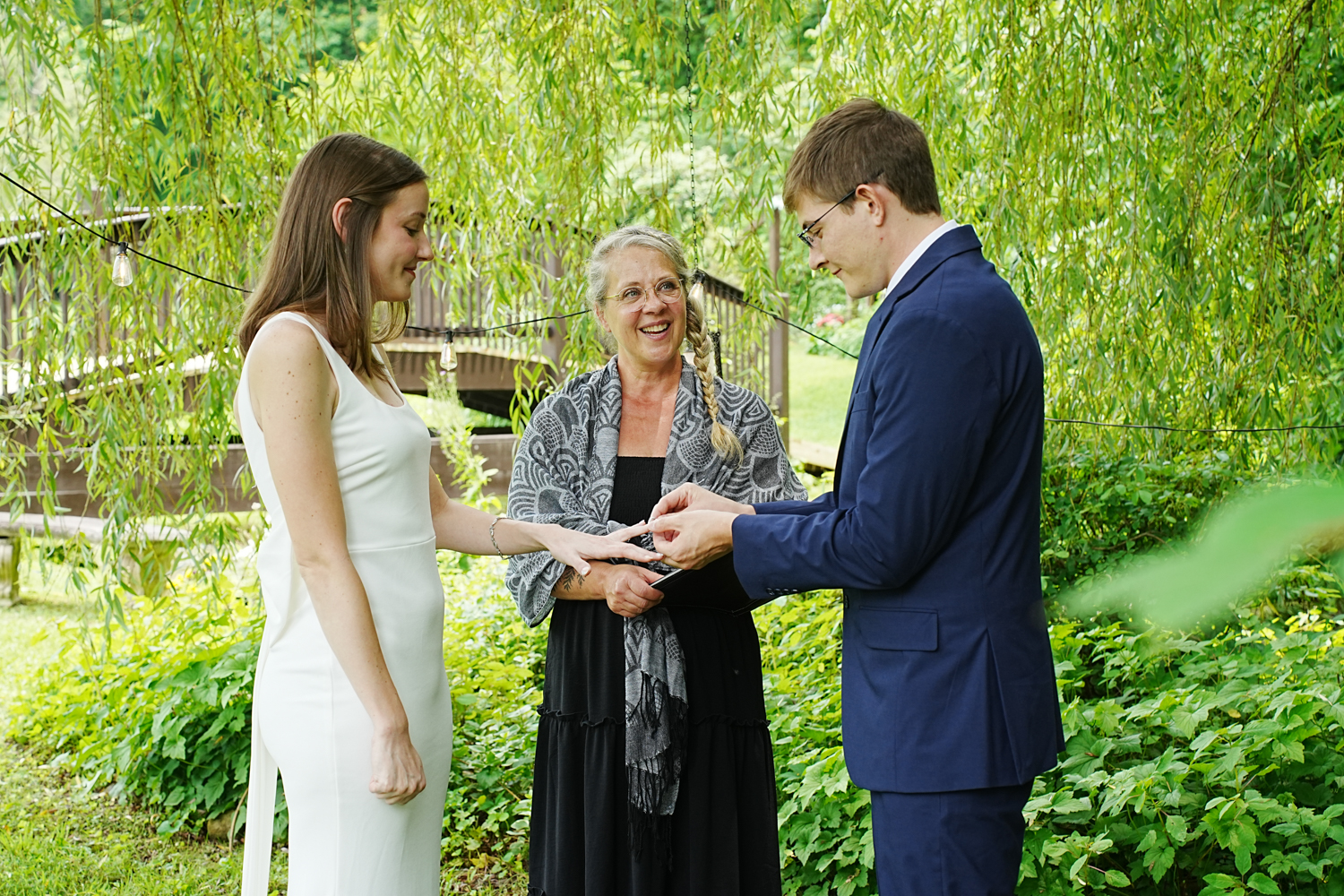 Simple couples only ceremony under a willow tree with a woman officiant