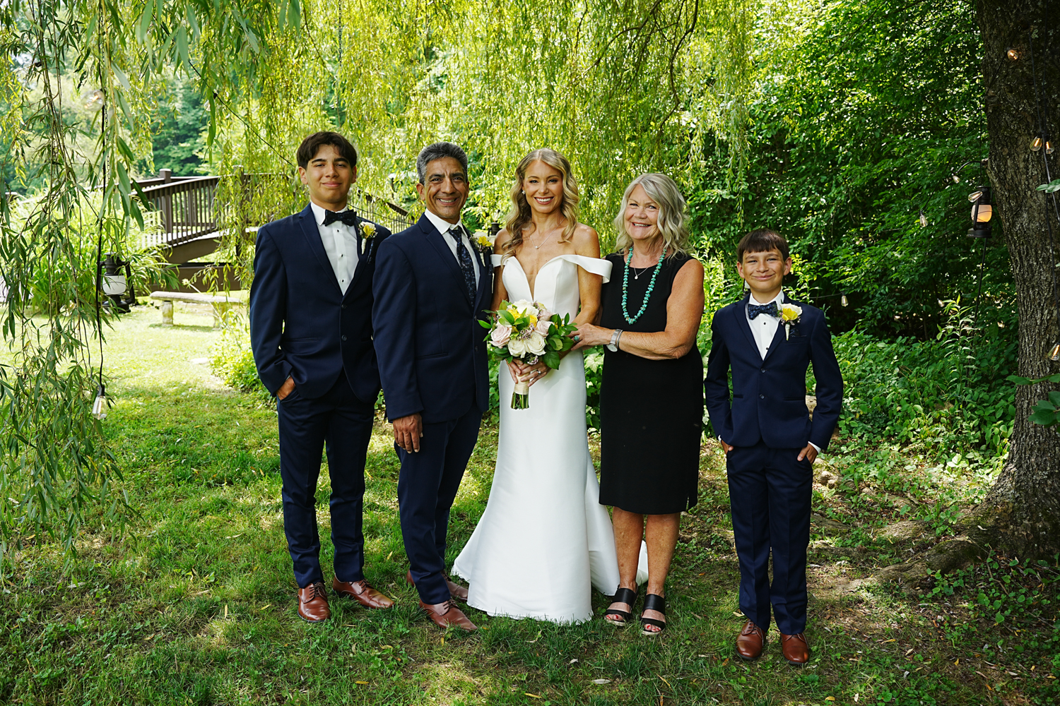 Small wedding with four guests under a willow tree in the summer