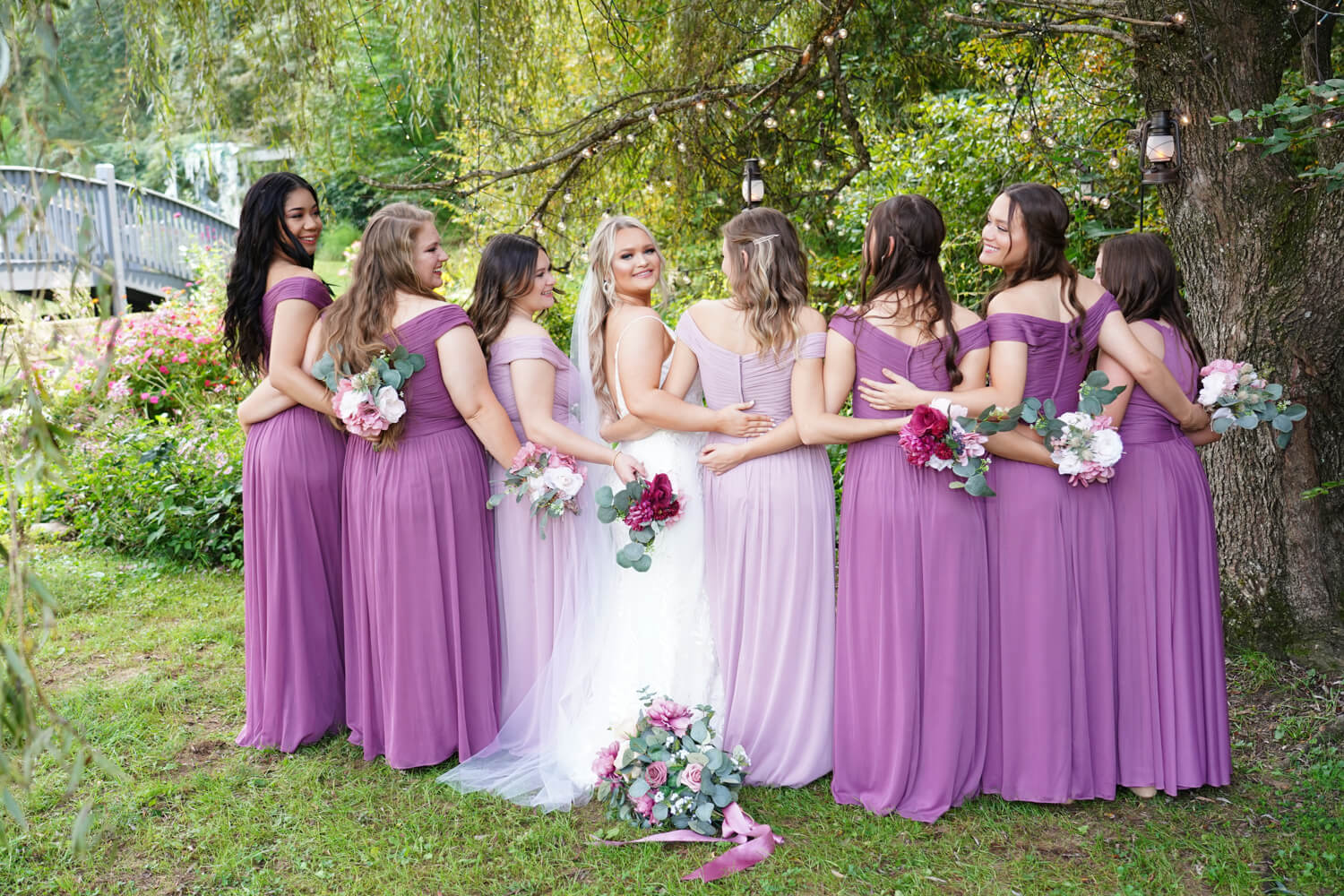 Bridesmaids posing under a willow tree in early fall