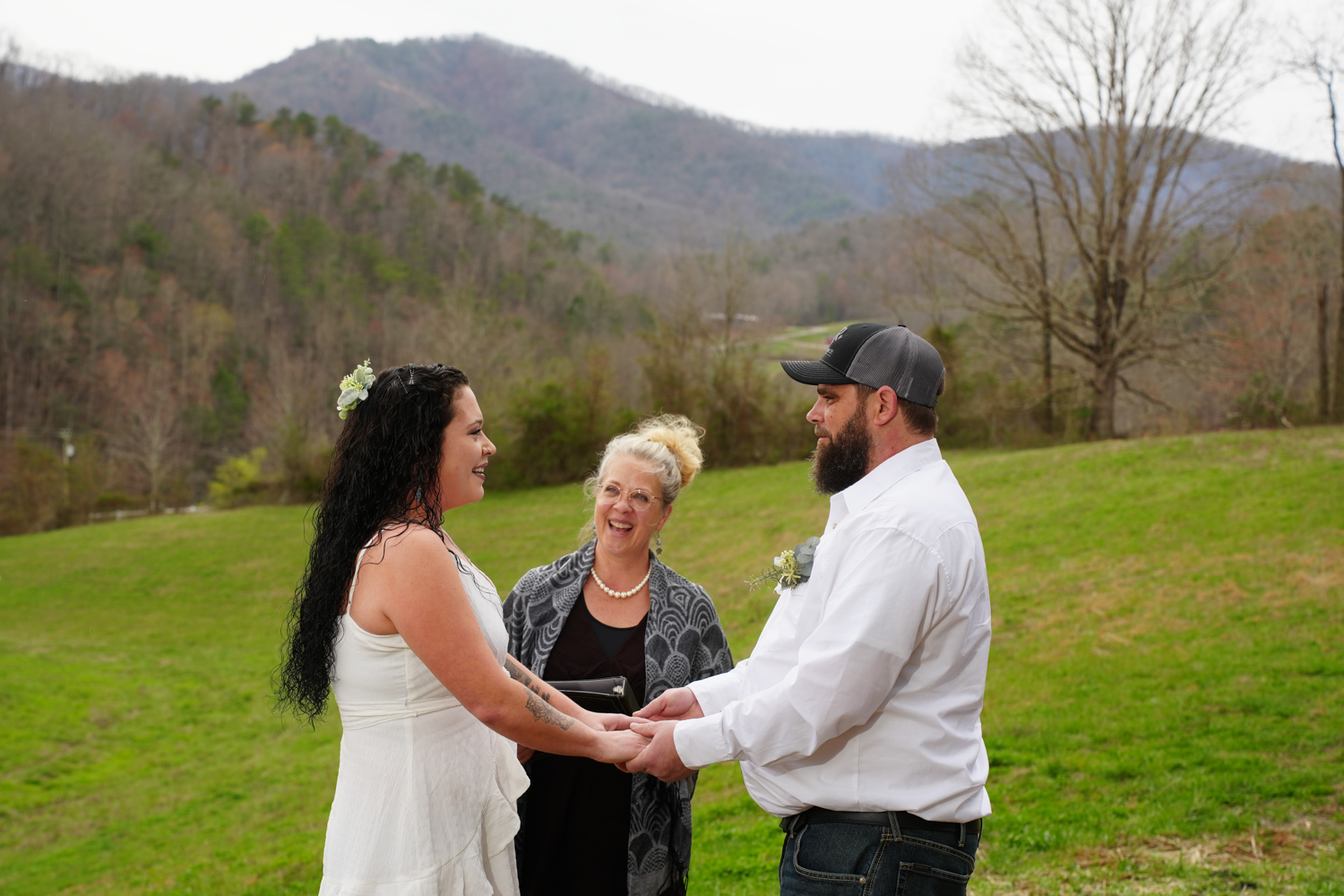 Woman officiant performing an informal couples only ceremony in the mountains of Pigeon Forge in the early spring