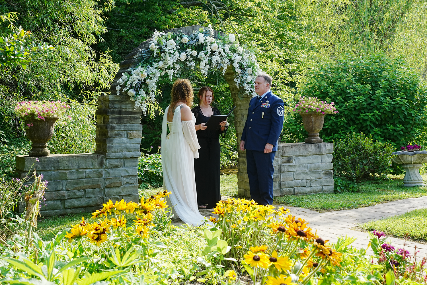 Abi officiating a wedding at the stone arch ceremony site at Honeysuckle Hills in Pigeon Forge TN