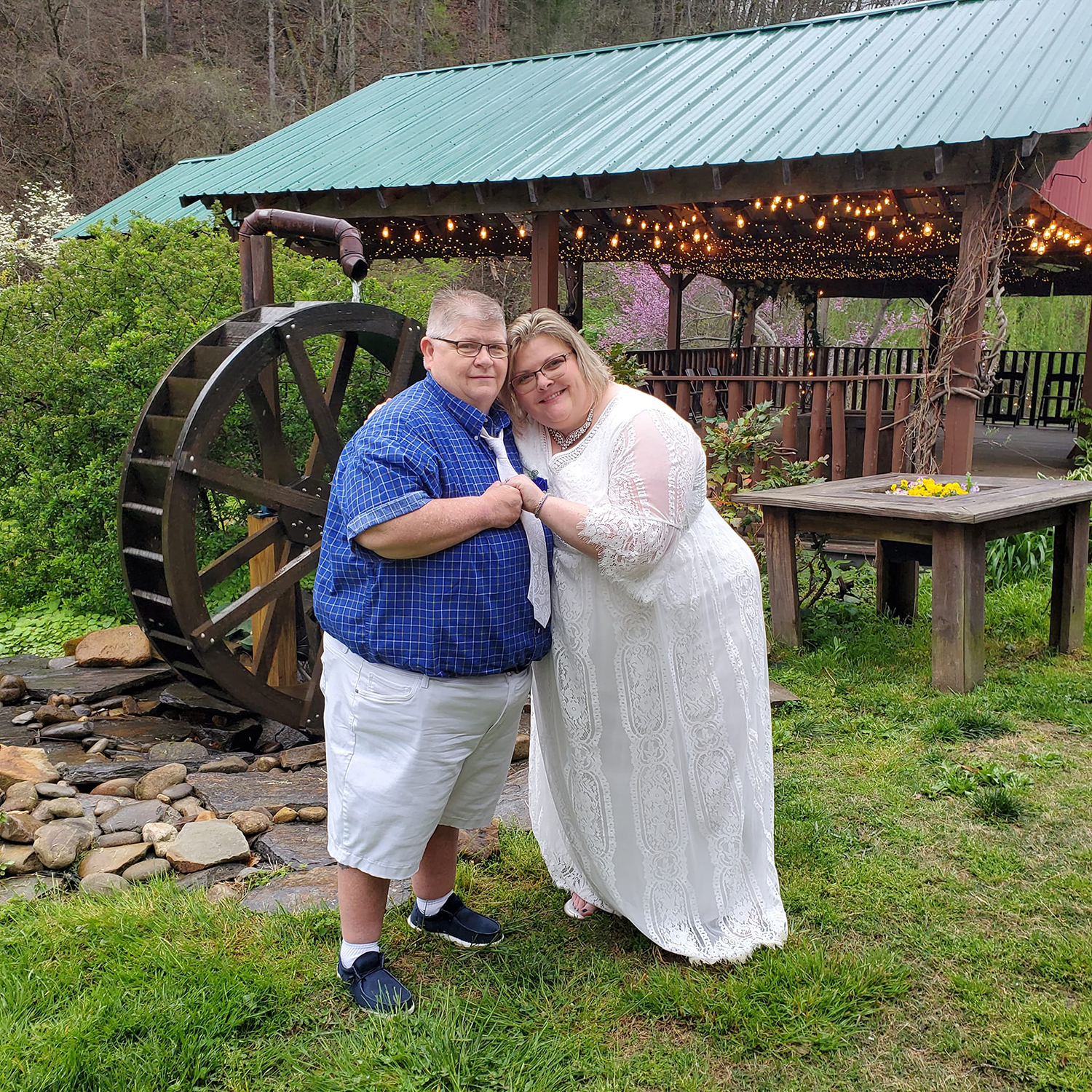 Bride posing with her bride at the water wheel at Honeysuckle Hills in Pigeon Forge
