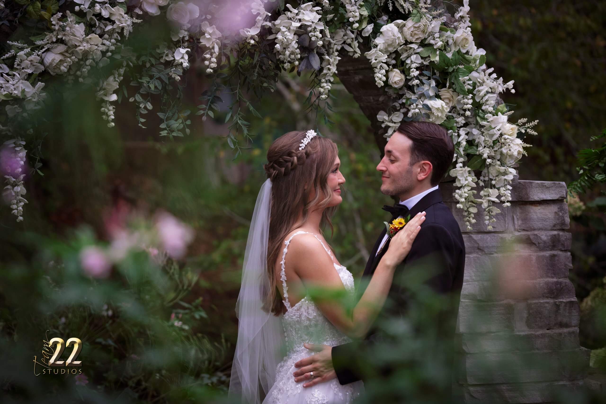 Bride and groom in a summer garden at a stone arch in Pigeon Forge