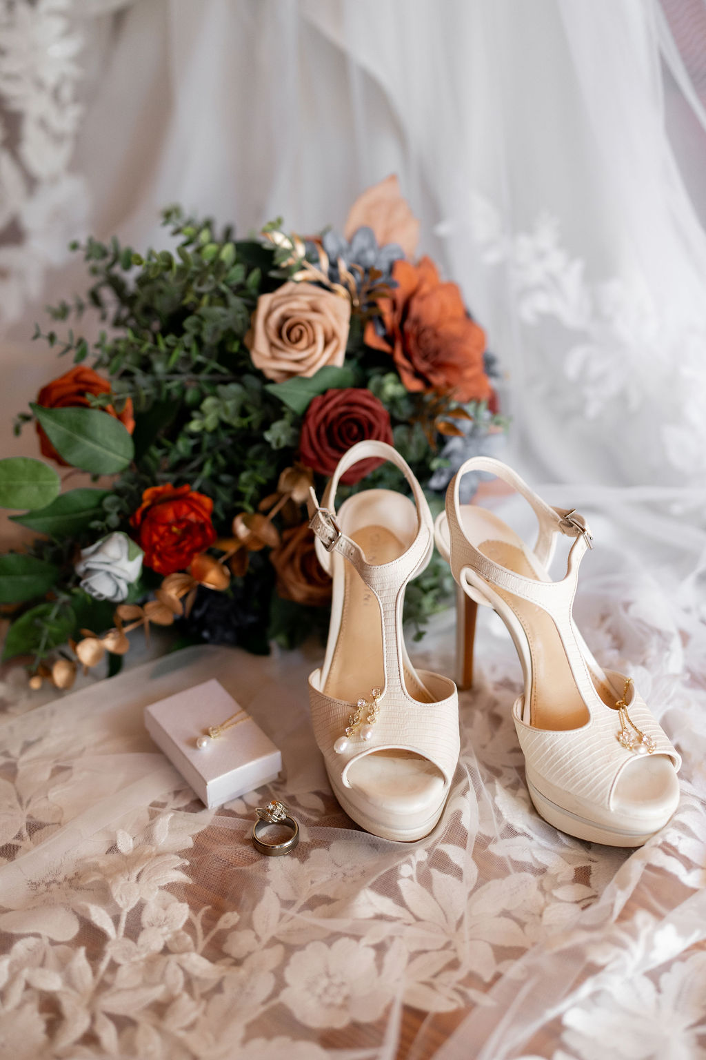 Wedding details photographed atop a wedding dress during a luxury elopement at Honeysuckle Hills