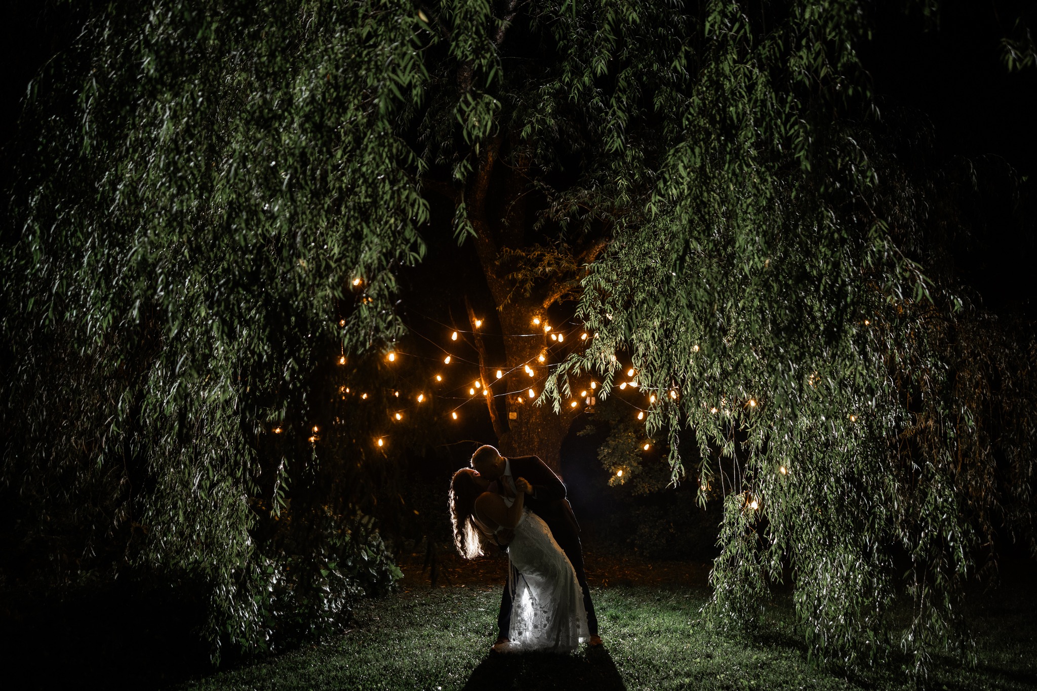 Adventure wedding at night beneath a willow tree at Honeysuckle Hills in Pigeon Forge