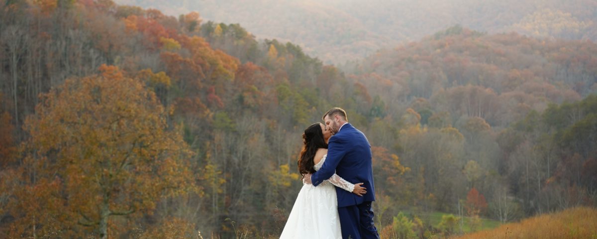 All-InclusiveWeddingVenue: Bride and groom enjoying a kiss privately at the mountain adventure site at Honeysuckle Hills in Pigeon Forge by one of their recommended photographers